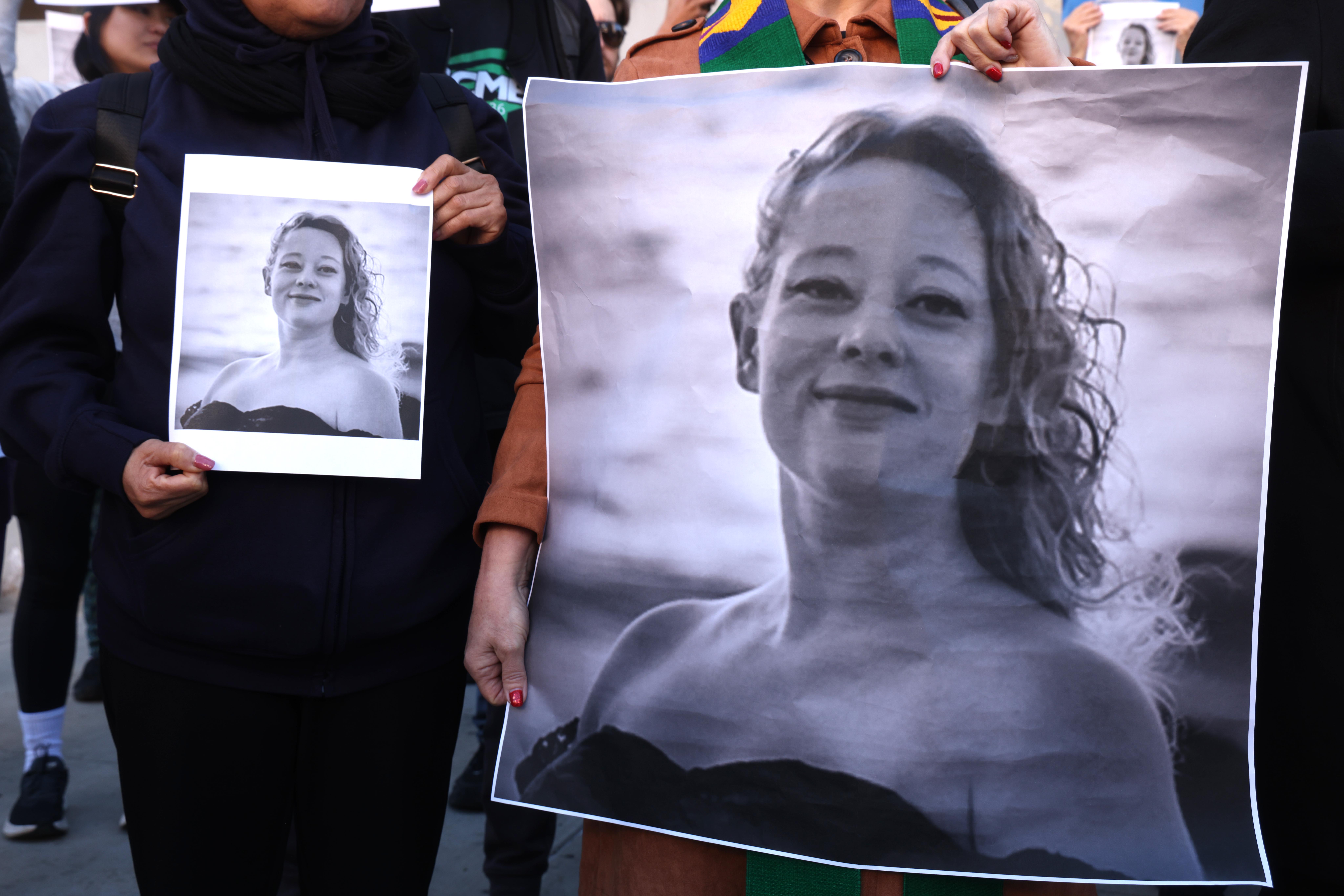 LOS ANGELES,  CA  - JANUARY 8, 2026  Dozens, holding photos of Renee Nicole Good, protest her death a day after an ICE agent killed Good in Minneapolis, in front of the Federal Building in downtown Los Angeles on January 8, 2026. The protest was organized by Clergy and Laity United for Economic Justice (CLUE). (Genaro Molina/Los Angeles Times via Getty Images)