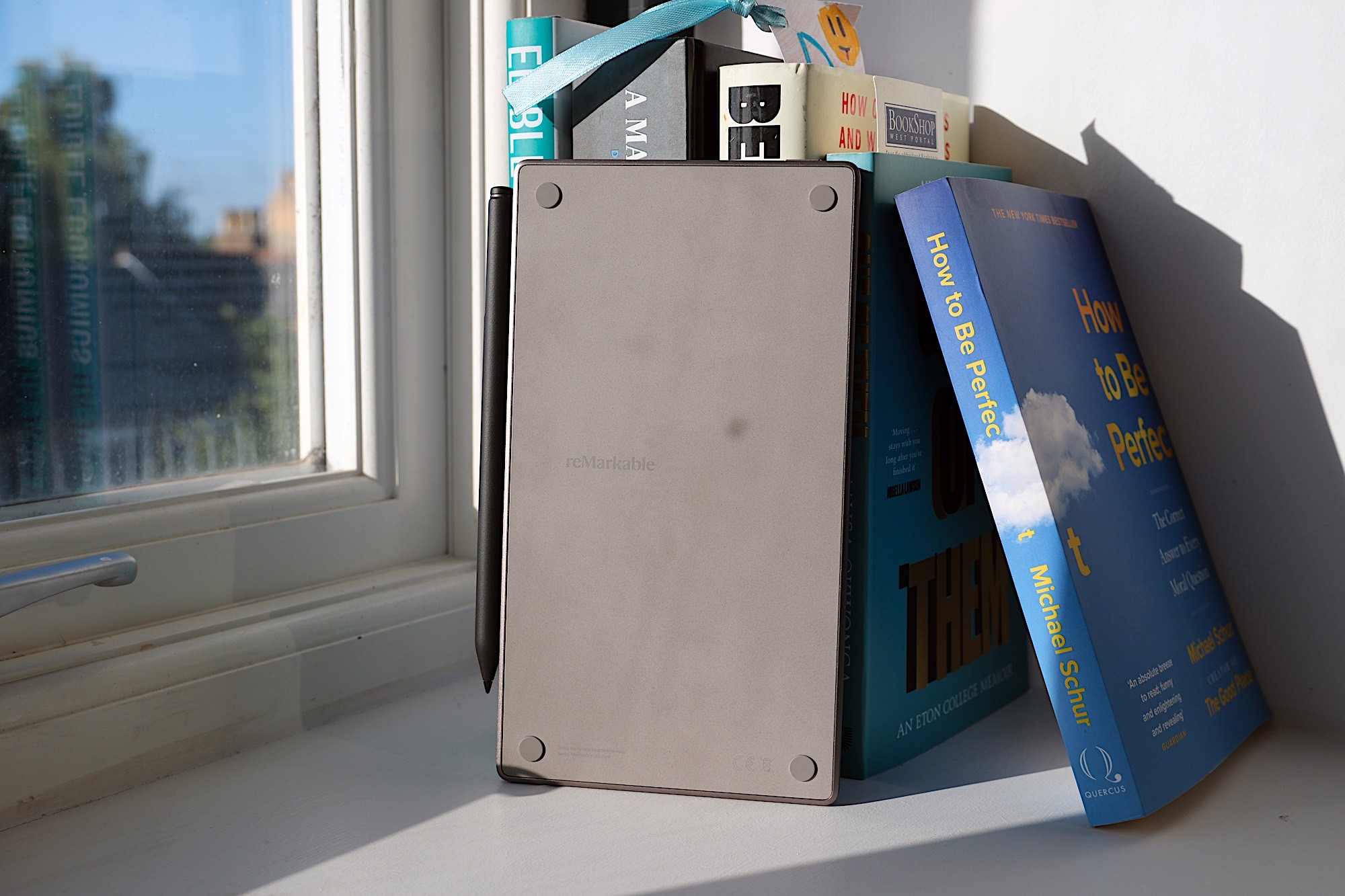 Image of the rear of a Paper Pro Move in front of some books