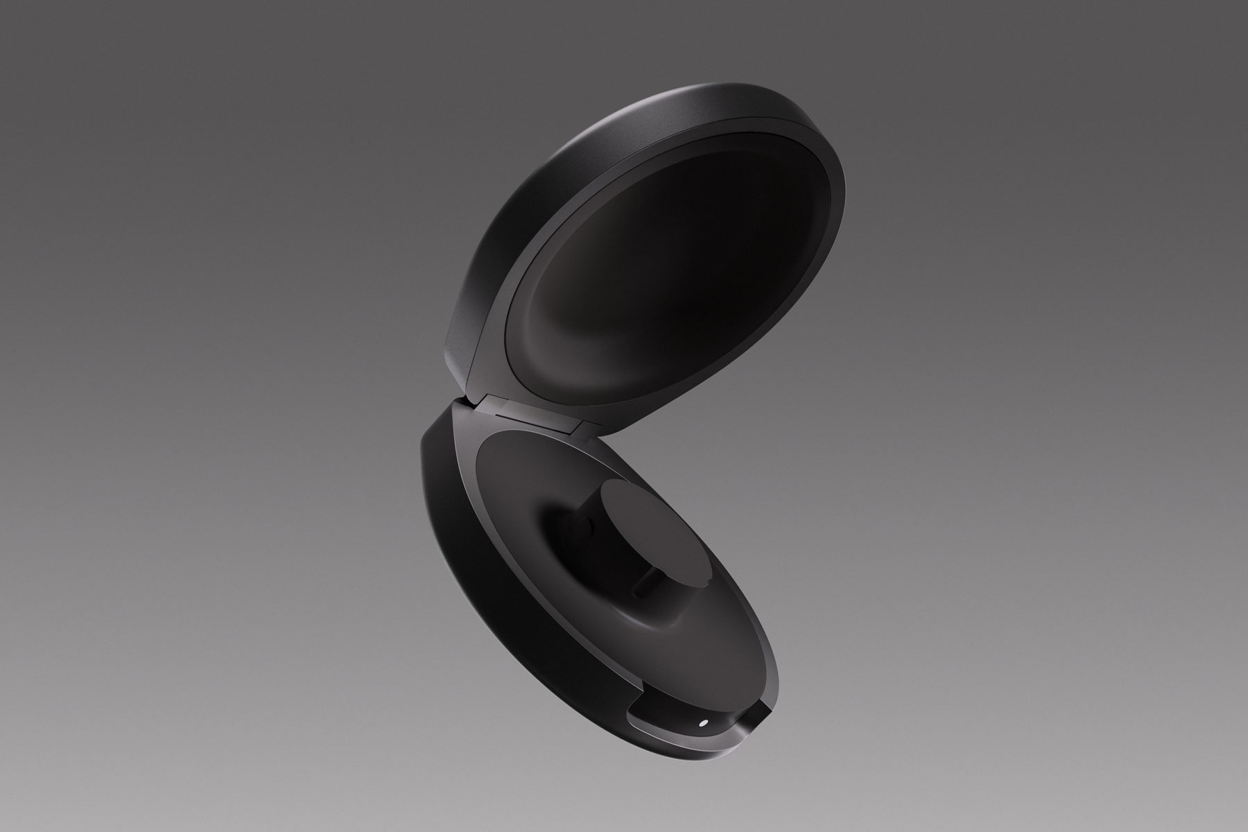 Image of the Oura Ring 4 charging case, in black, on a grey/black background.