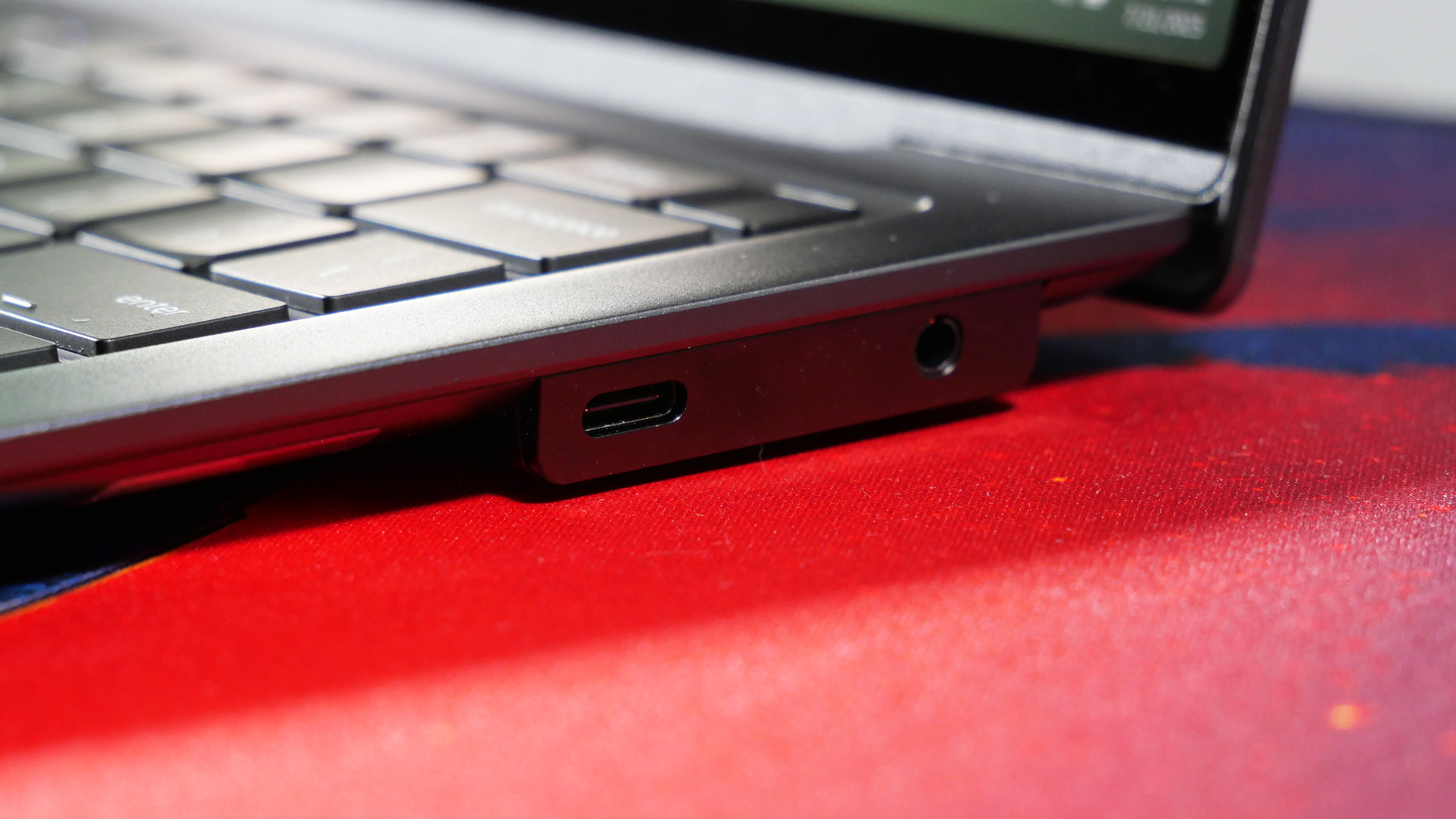 A close-up of the right side of the Lenovo ThinkPad X9-14 Aura Edition, focusing on a USB-C port and 3.5mm audio jack.
