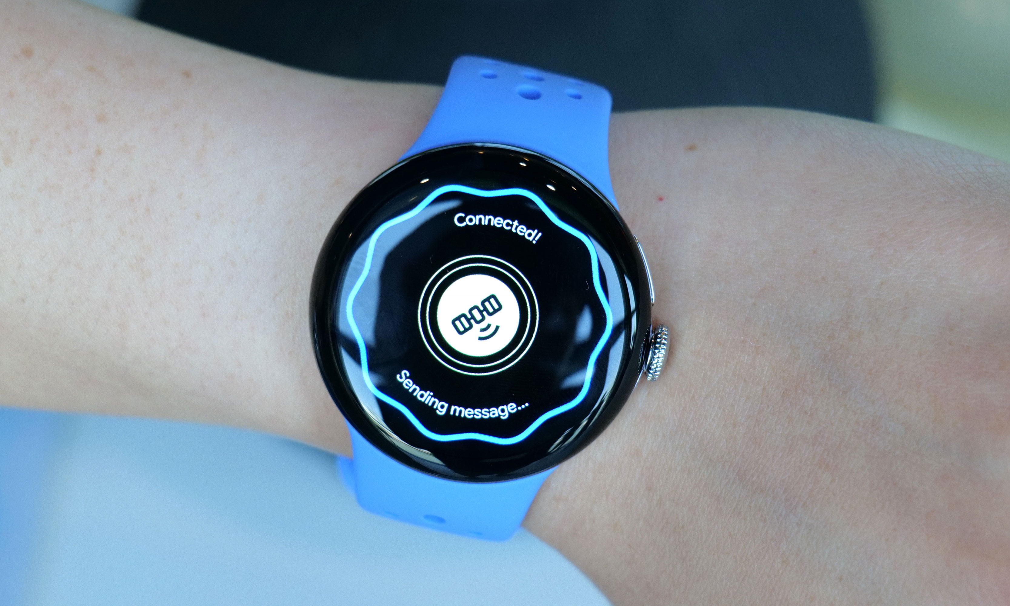 A Pixel Watch 4 with a satellite graphic on its screen showing the word 