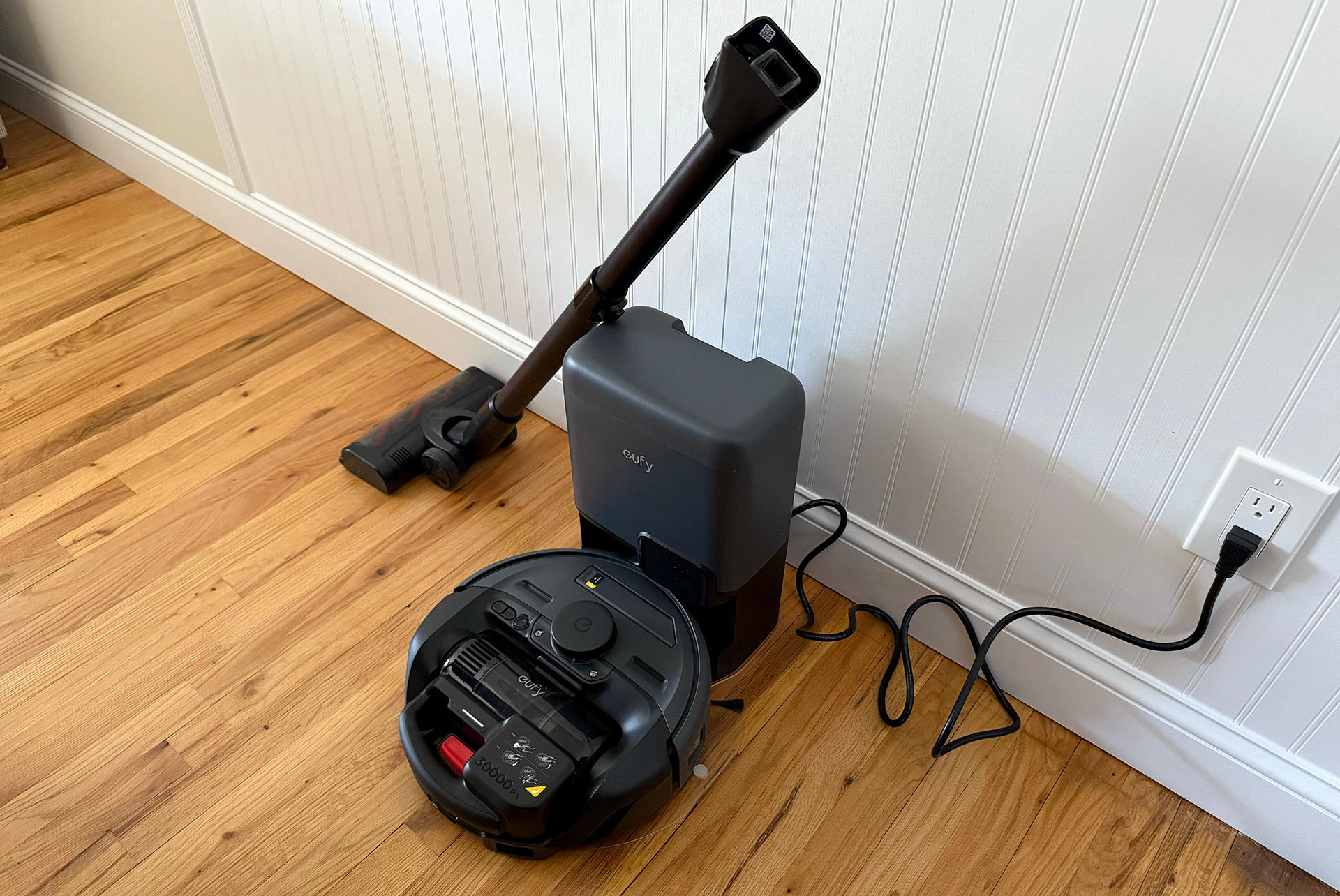 A Eufy E20 robot vacuum with detachable stick vacuum.