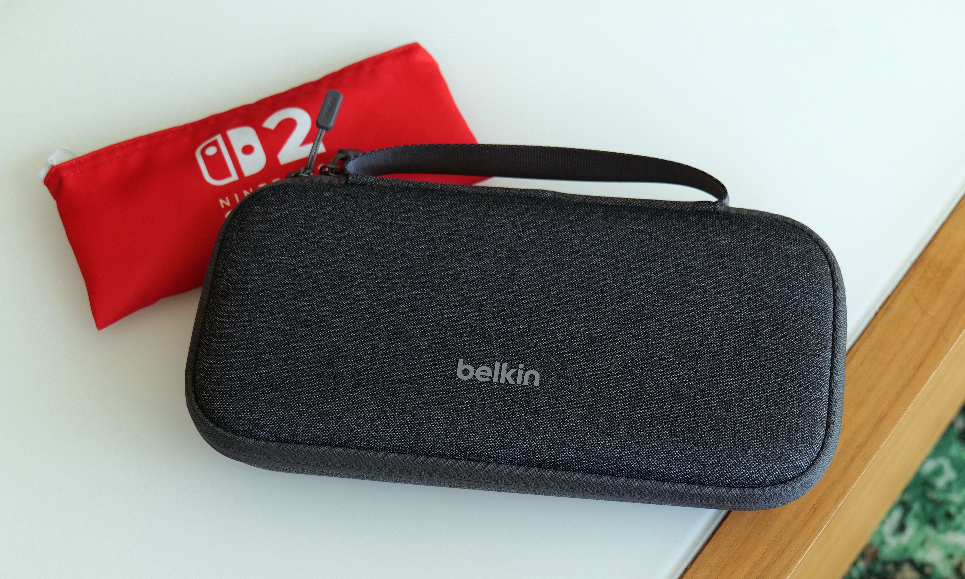 The Belkin Charging Case for Nintendo Switch 2 features a polyester exterior in three colors (gray, green and tan) and a velvet-lined interior.