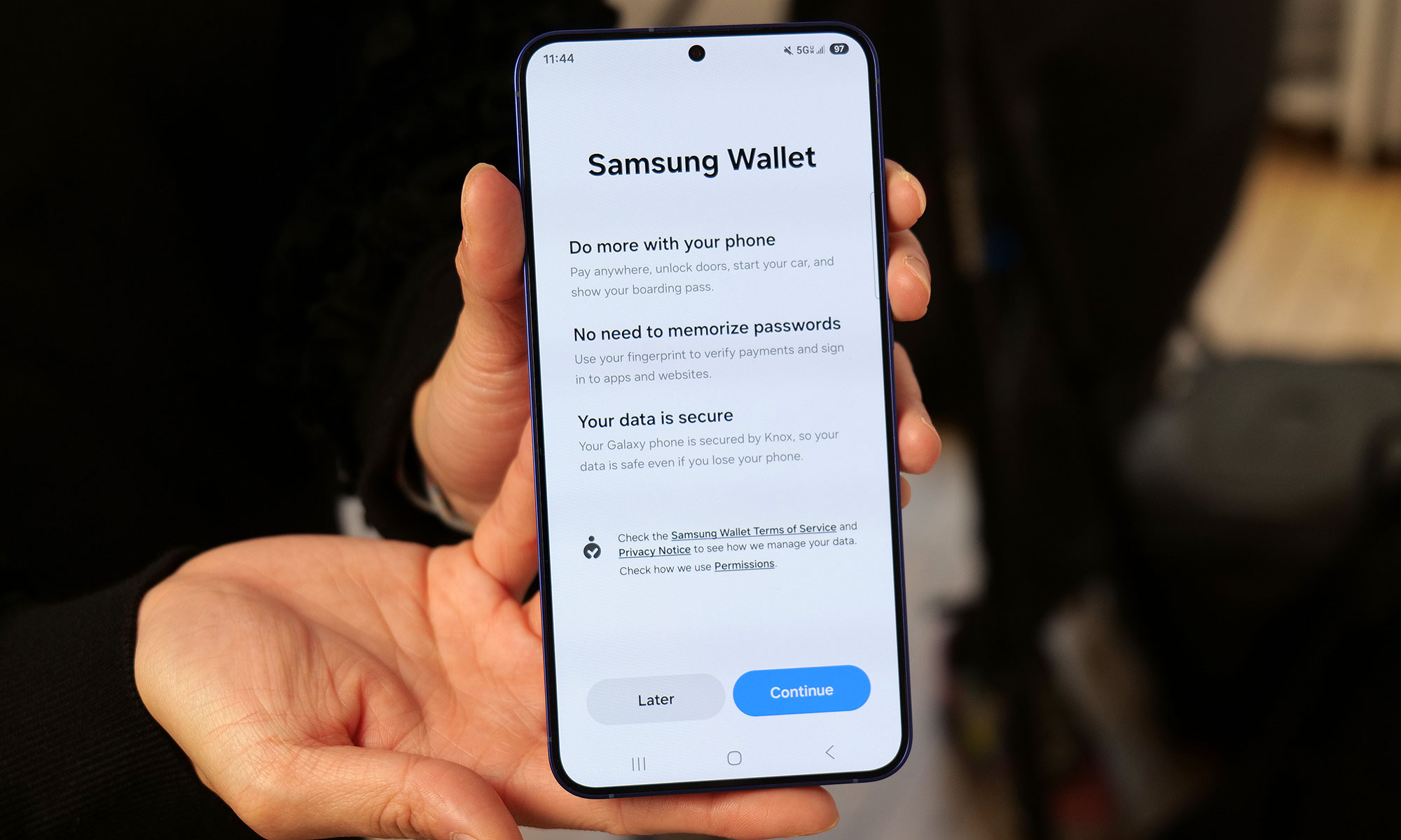 A person’s hands holding a Galaxy S25 series phone showing Samsung Wallet.