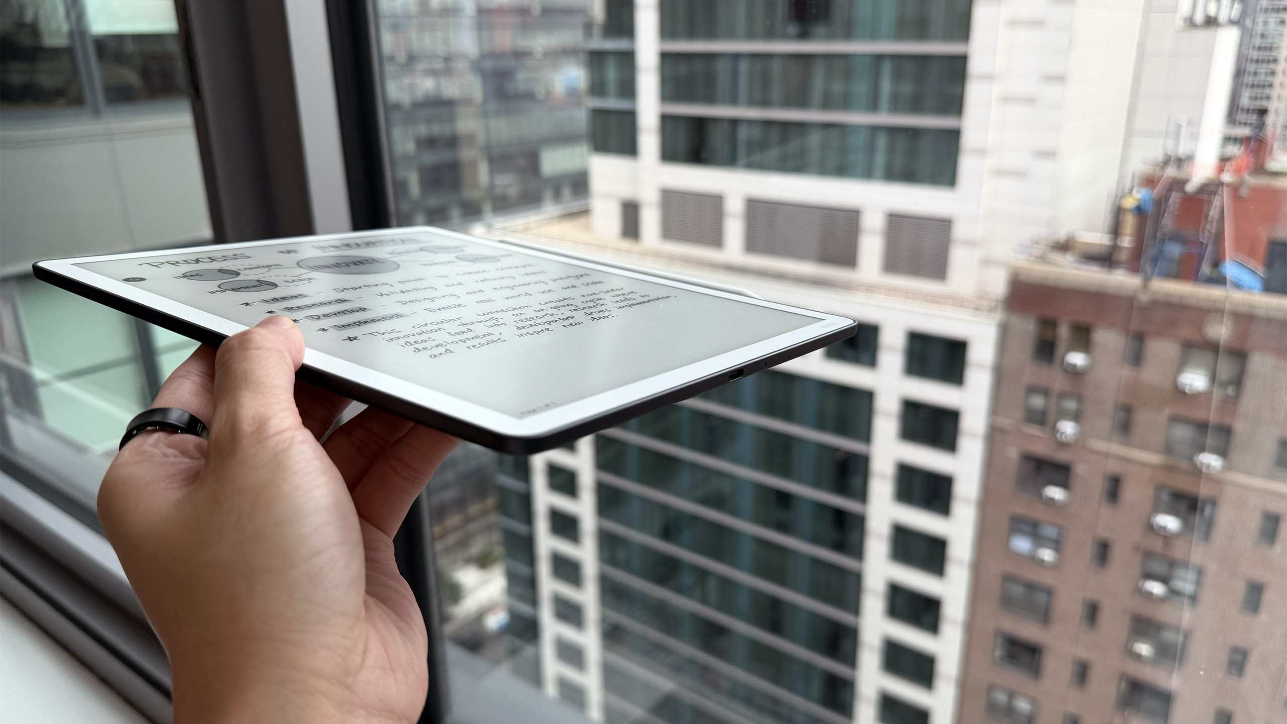 Side view of the Kindle Scribe 3 held in mid-air.