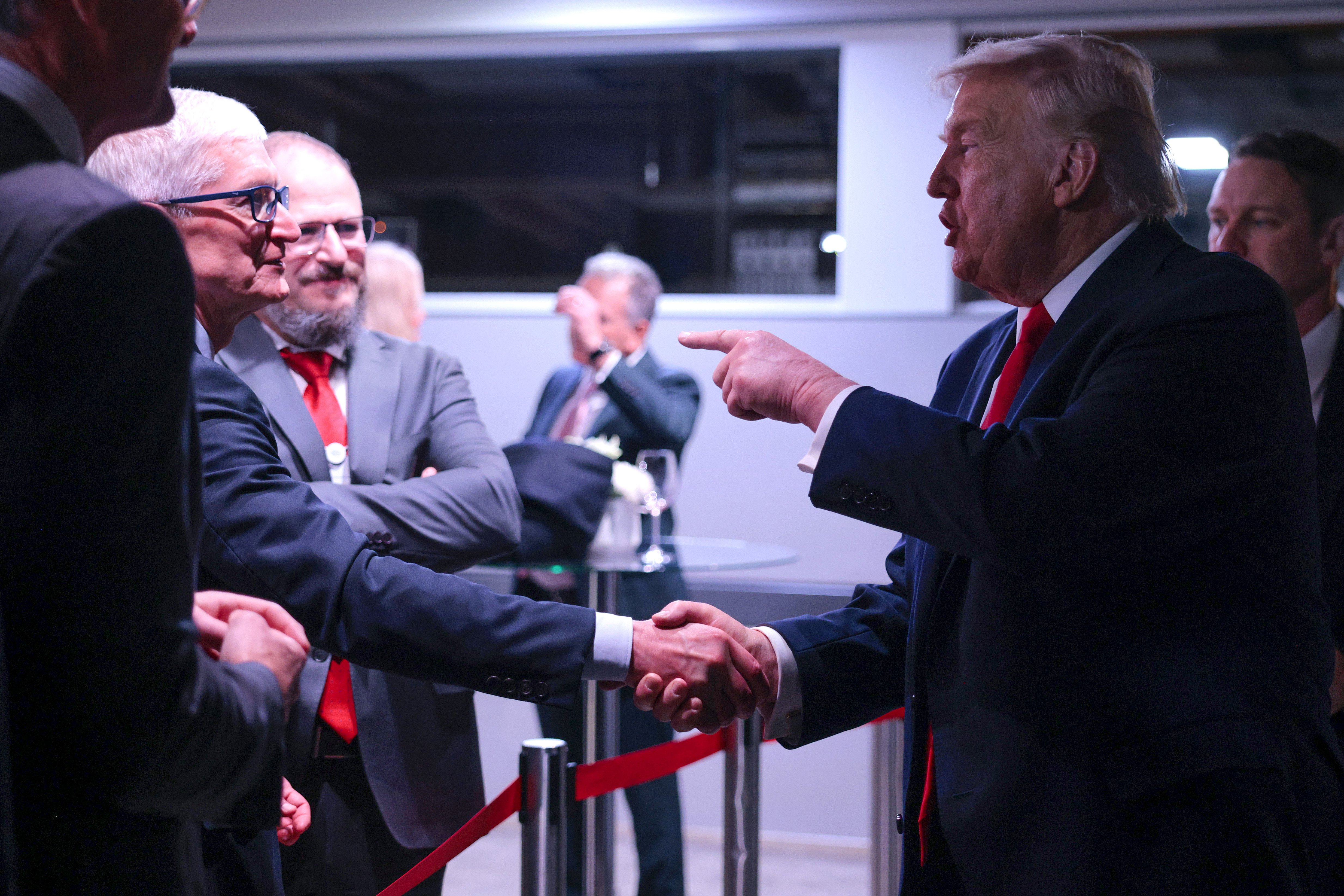 DAVOS, SWITZERLAND - JANUARY 21: U.S. President Donald Trump (R) speaks to Apple CEO Tim Cook (L) as he attends a reception for business leaders at the World Economic Forum (WEF) Annual Meeting on January 21, 2026 in Davos, Switzerland. The annual meeting of political and business leaders comes amid rising tensions between the United States and Europe over a range of issues, including Trump's vow to acquire Greenland, a semi-autonomous Danish territory. (Photo by Chip Somodevilla/Getty Images)