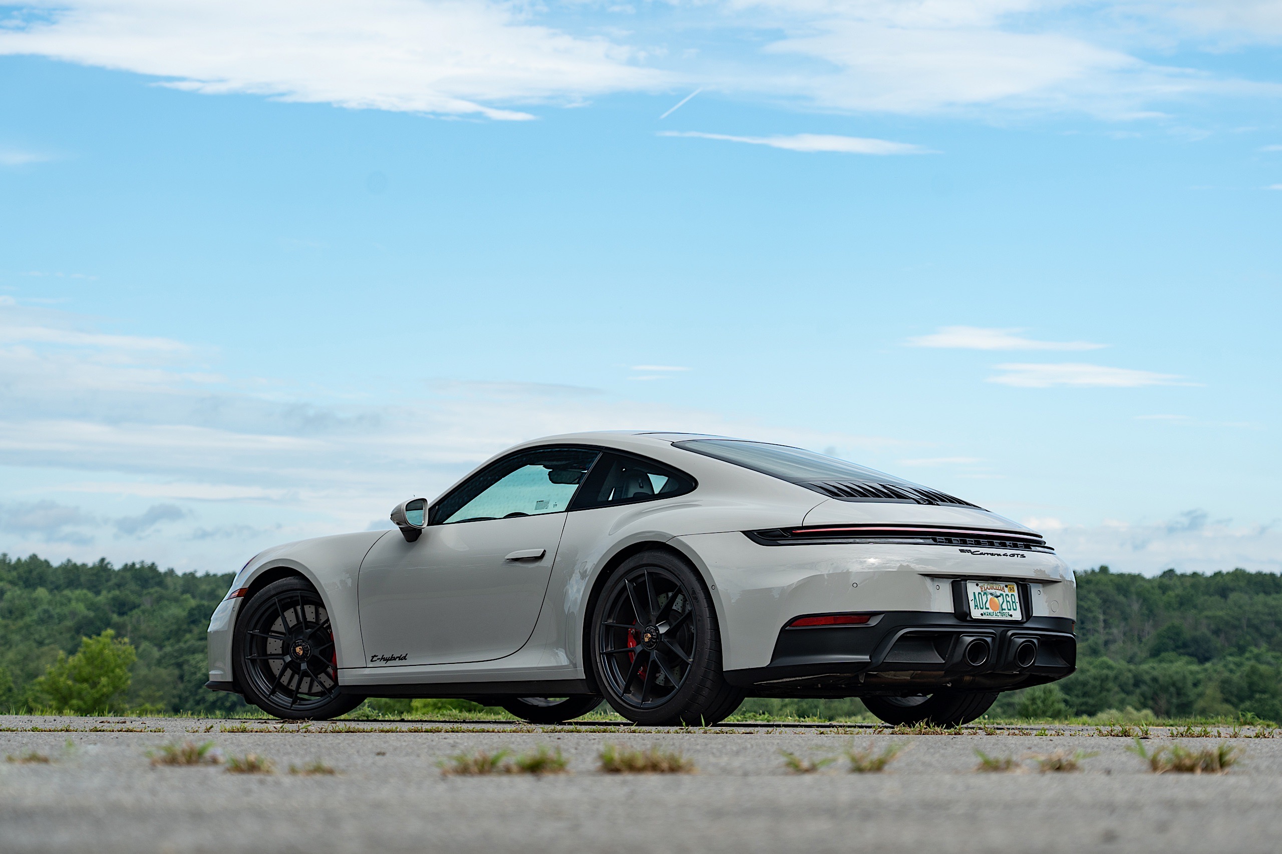The 2025 Porsche 911 GTS hides its hybrid tech so well that the branding on the door is the only indicator this isn't a normal 911. 