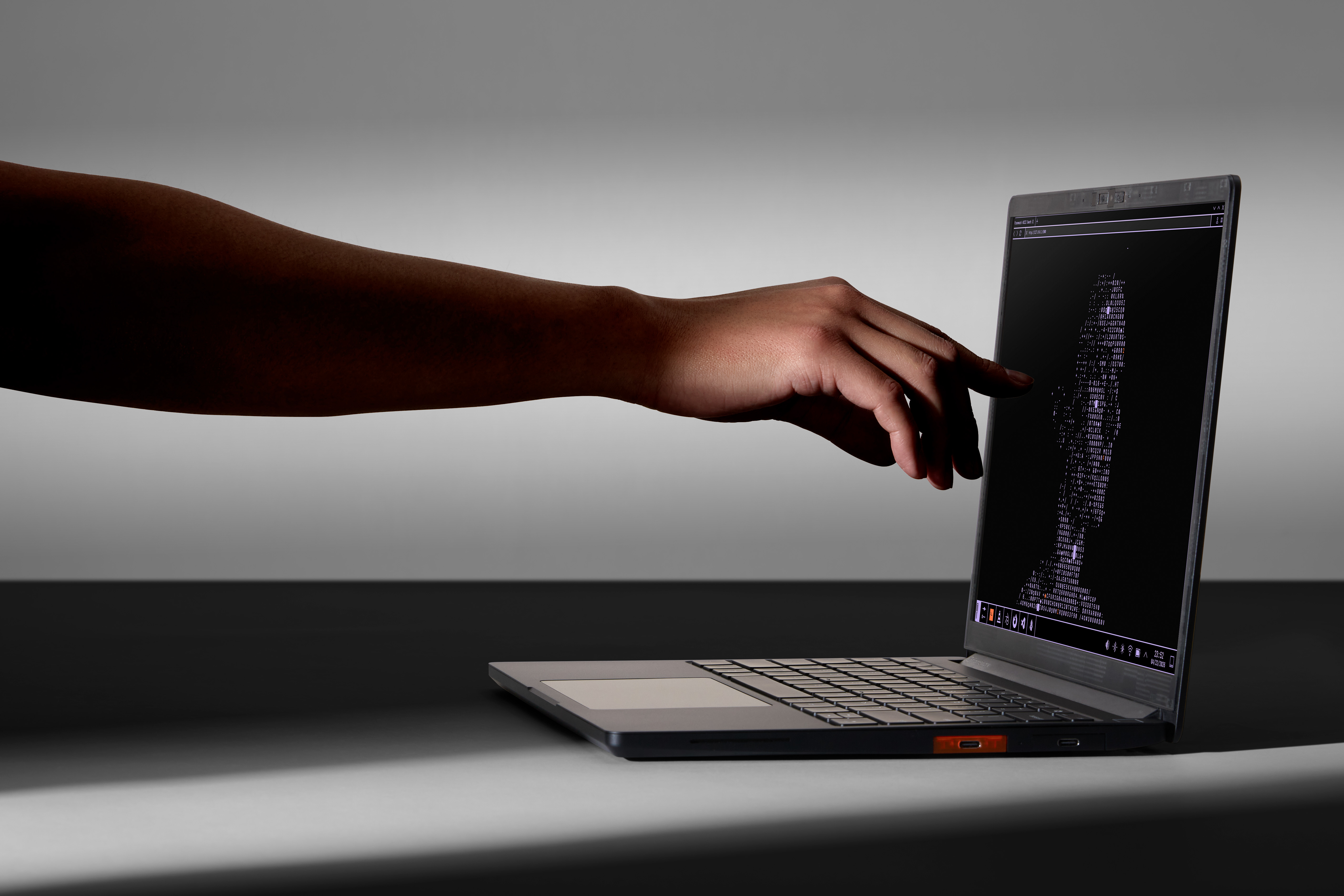 Image of the Framework 13 Pro being pointed at to demonstrate it has a touchscreen