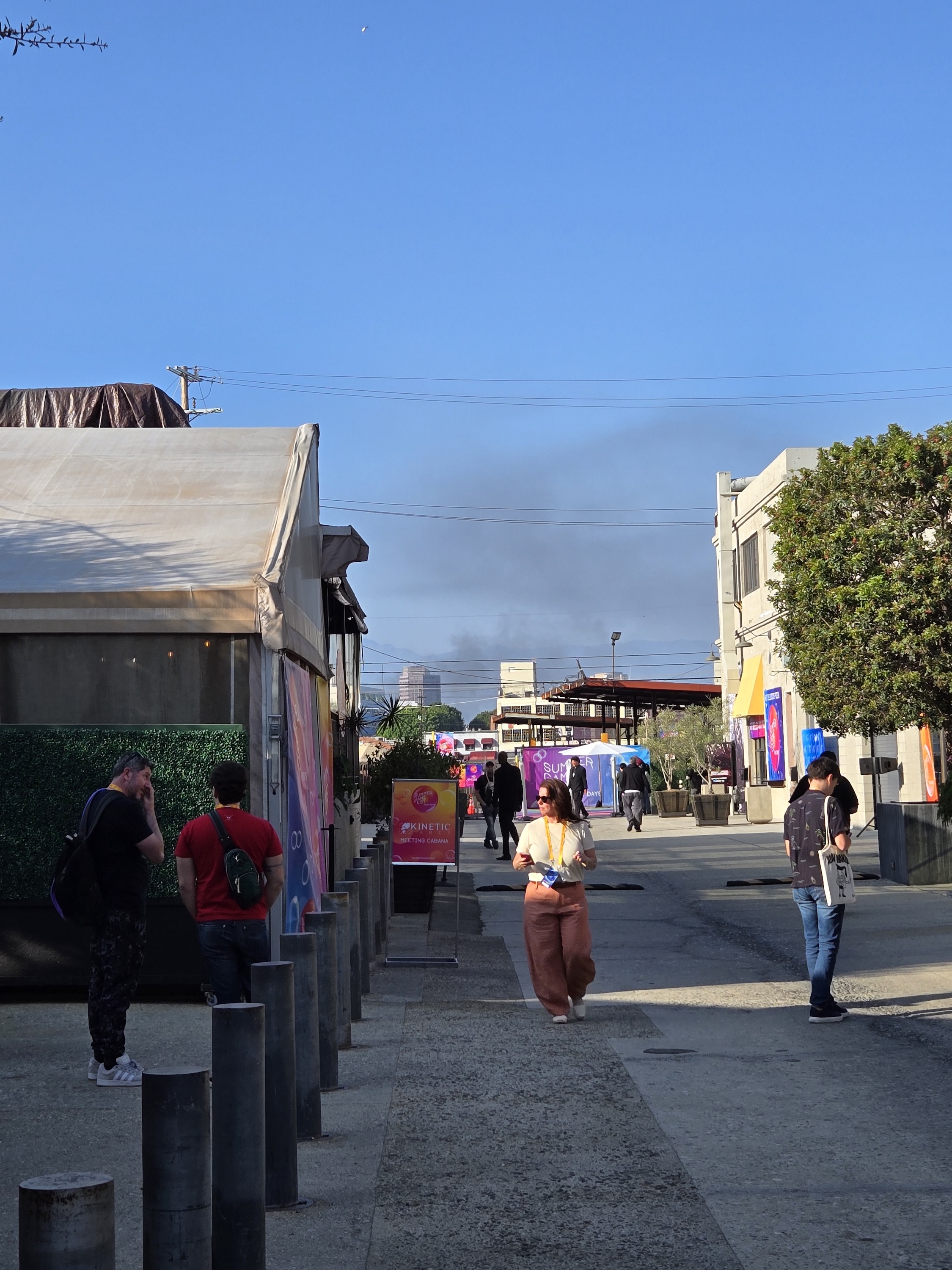 Black smoke from burning Waymo vehicles hovers over Summer Game Fest 2025 Play Days.
