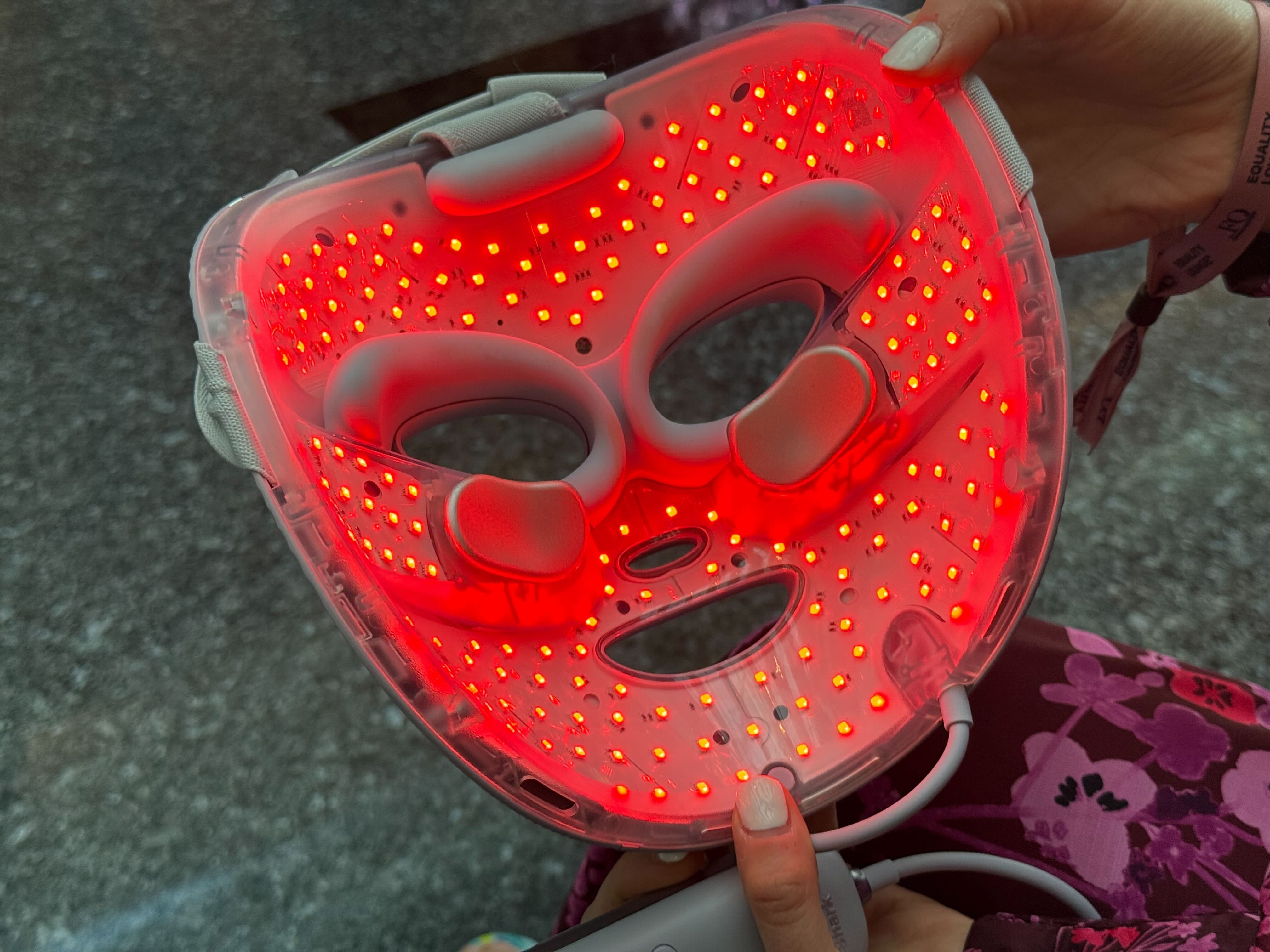 The inside of the Shark CryoGlow LED face mask, showing many red LED lights glowing.