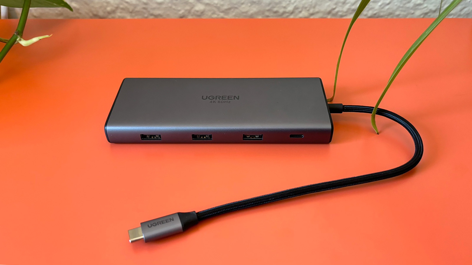UGreen Revodok Pro 109 usb-c hub sits on an orange background. 