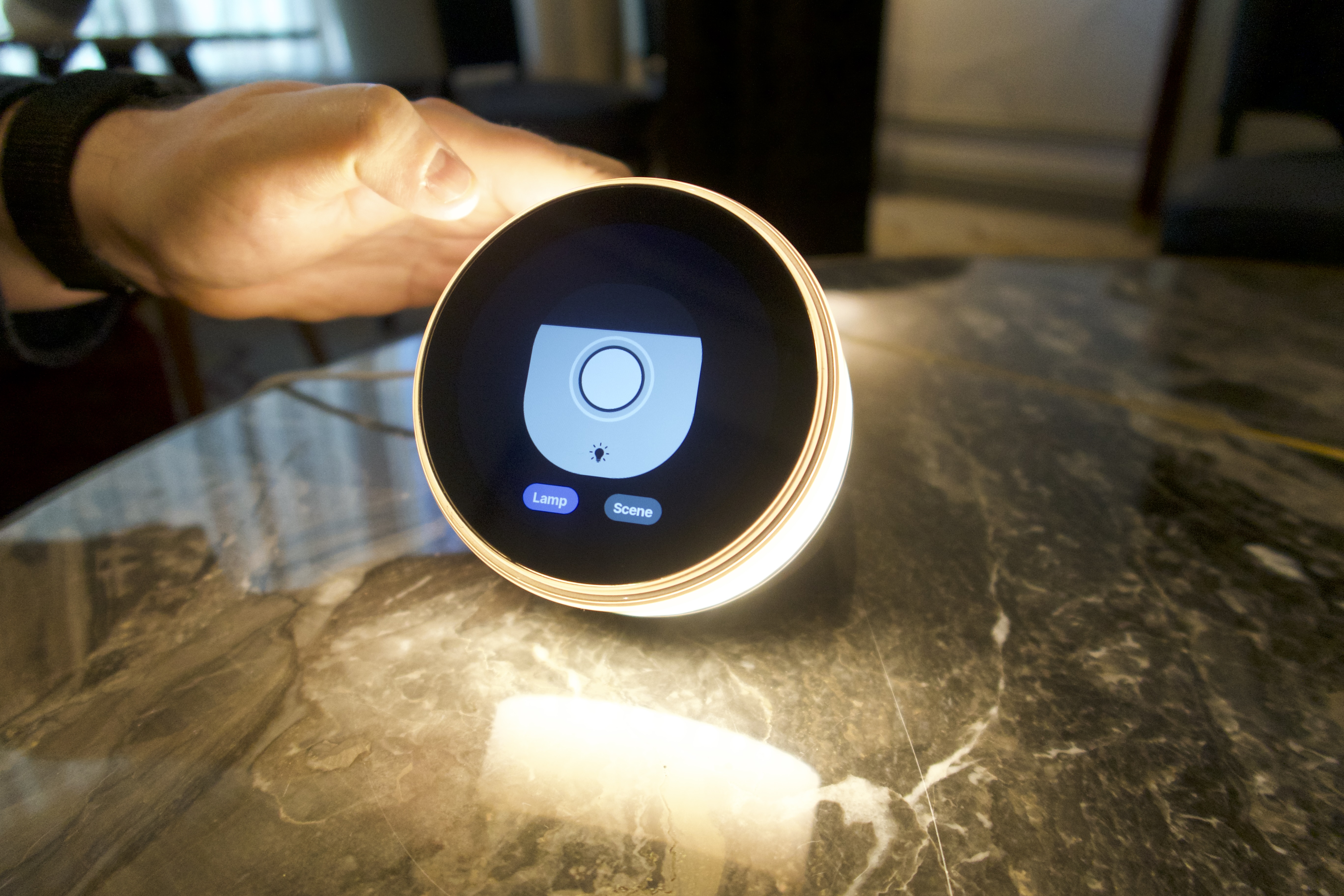 The Dreamie alarm clock is pictured displaying its brightness controls, and is glowing warm light