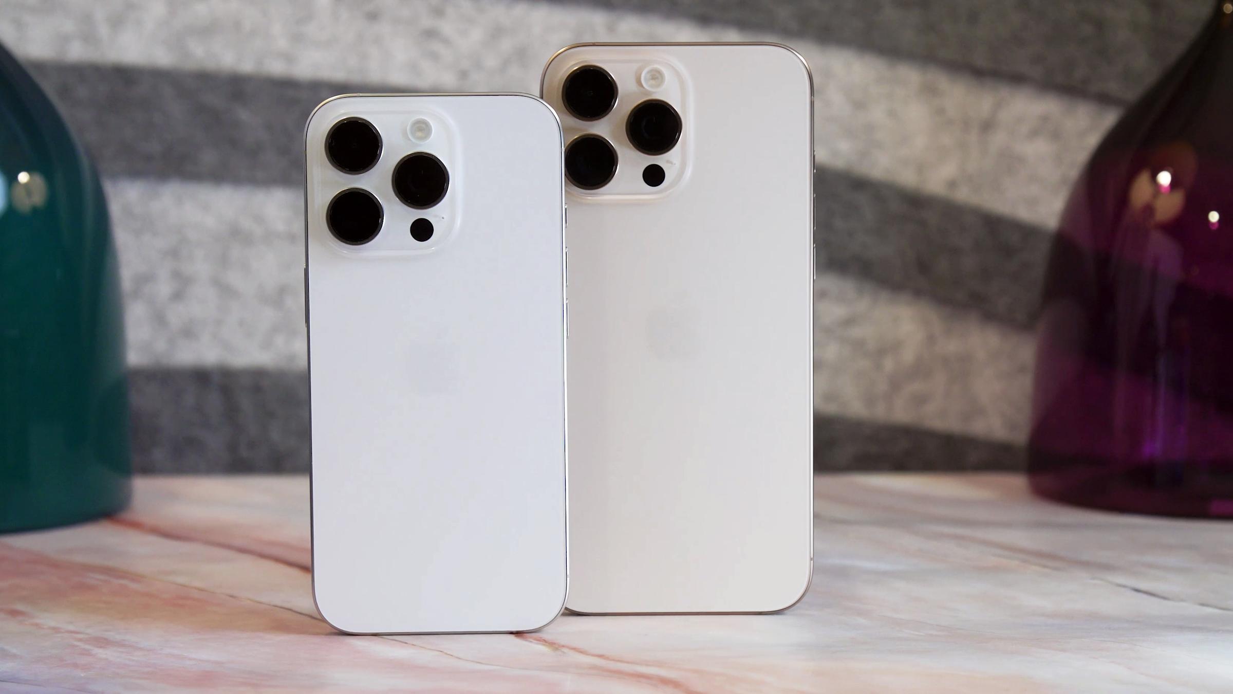 The iPhone 16 Pro and iPhone 16 Pro Max sitting on a table.