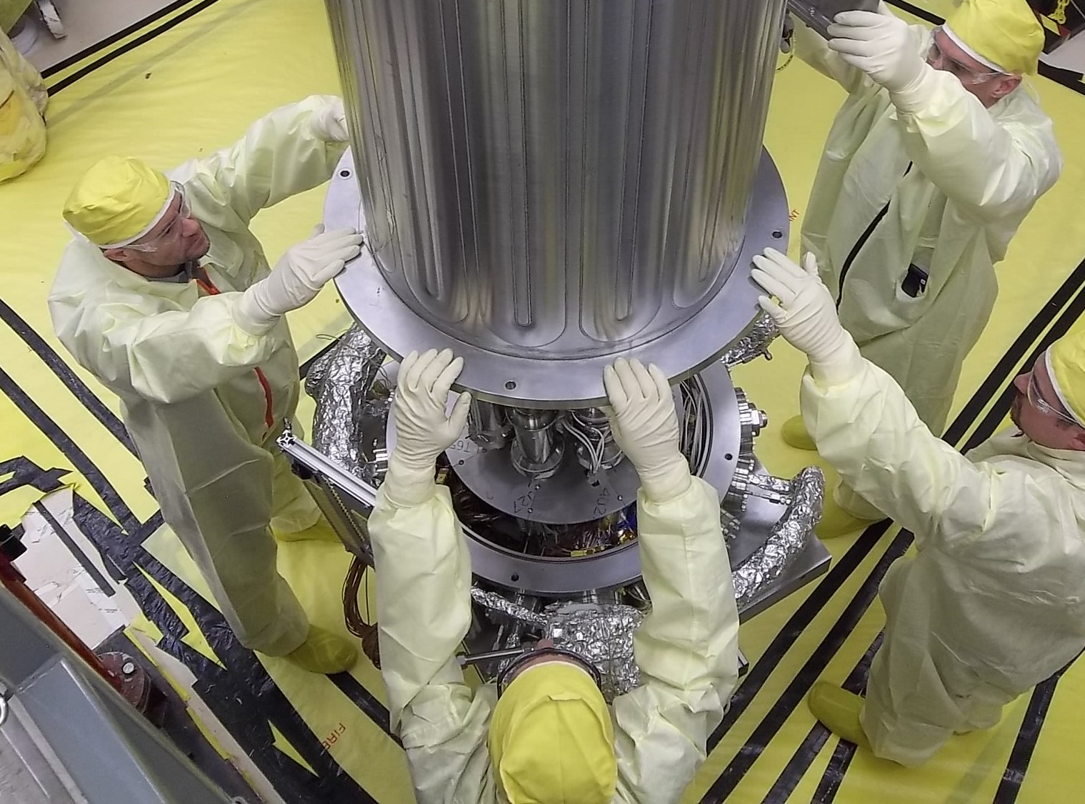 NASA and NNSA engineers lower the wall of the vacuum chamber around KRUSTY system.