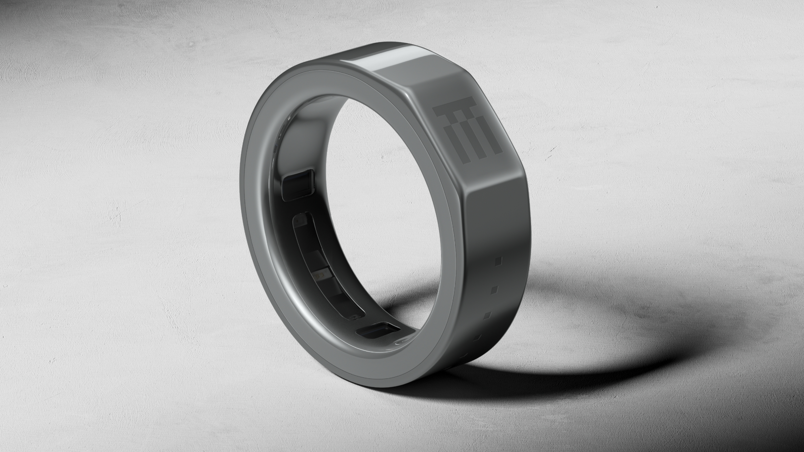 A ceramic and titanium R1 smart ring with a flat side.