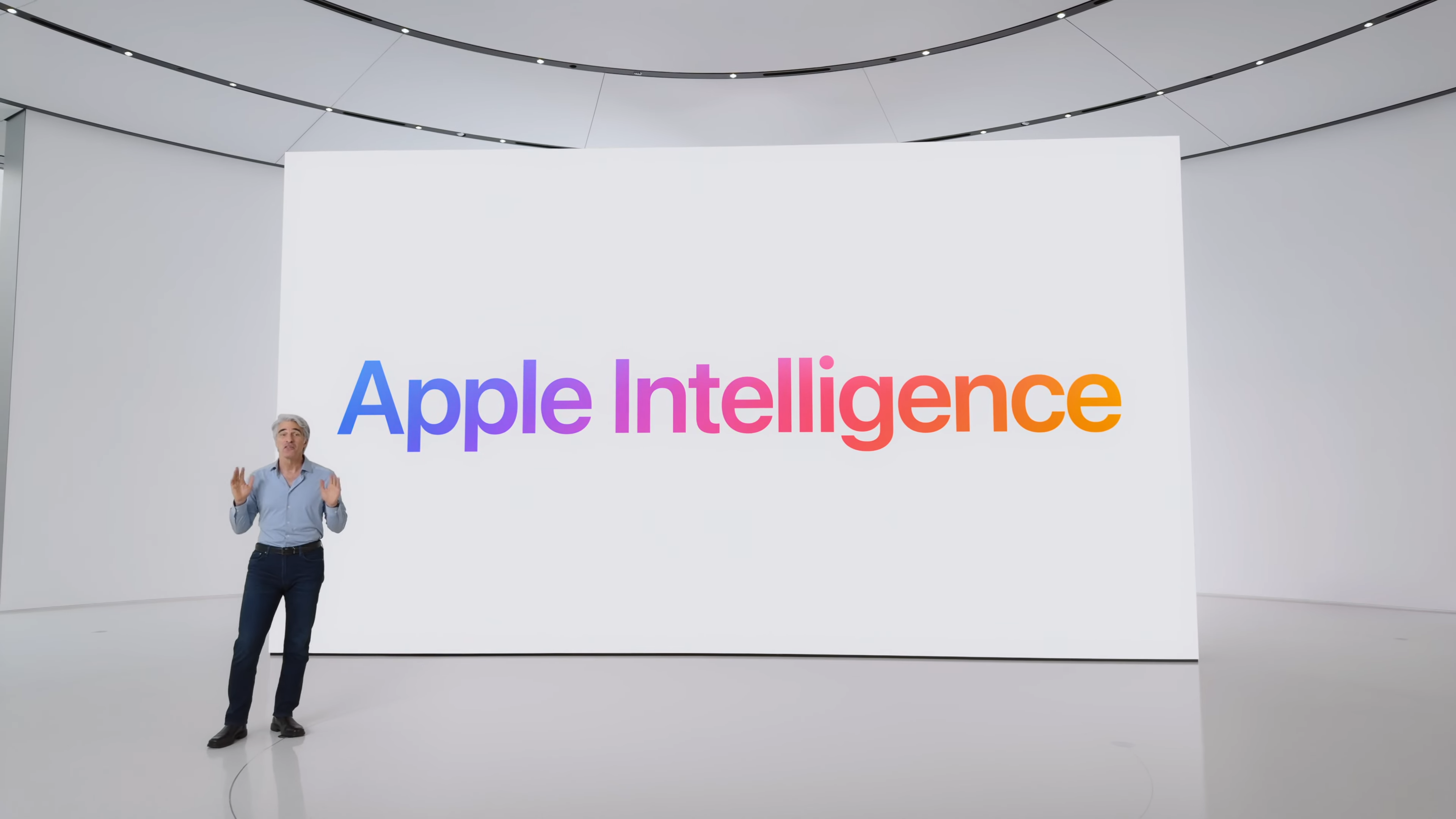 Apple's Craig Federighi in front of a board that reads, 