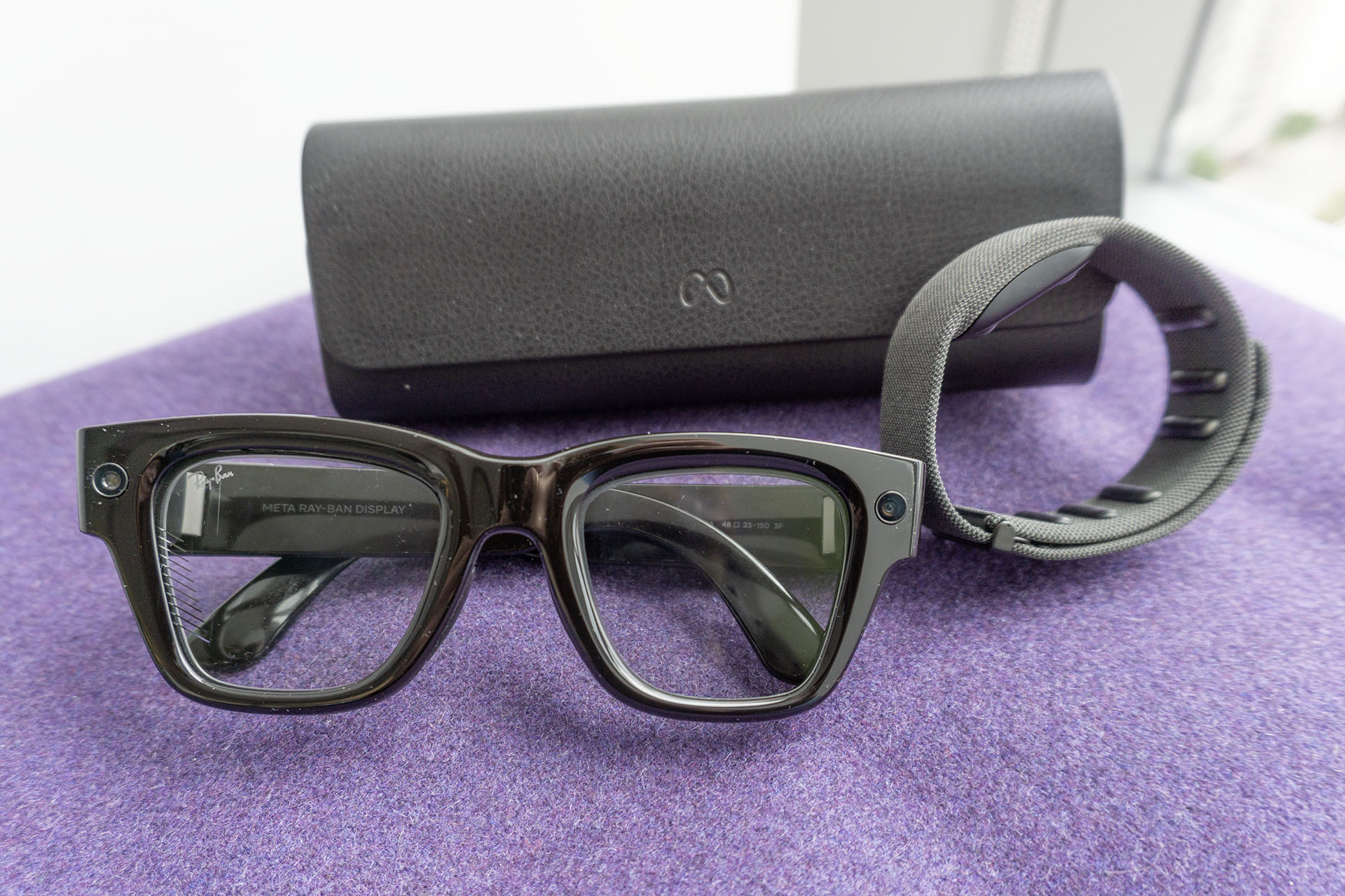 The Meta Ray-Ban Display glasses, charging case and neural band.