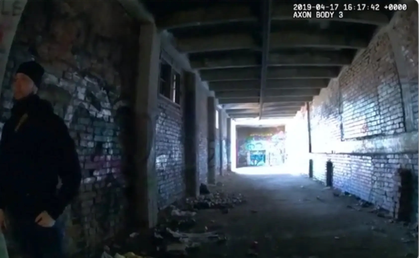 Footage of a dark covered passage from a first-person camera’s perspective.
