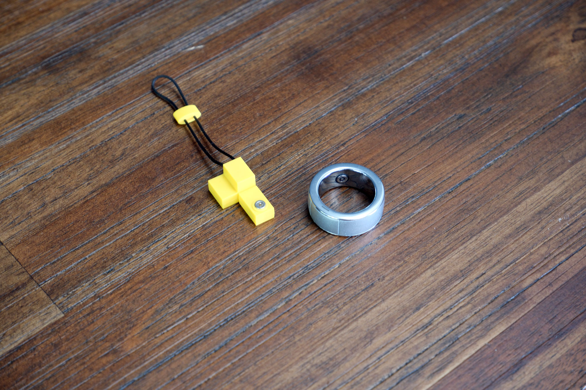 Close up of the Control Ring and charger for the Halliday Smart Glasses