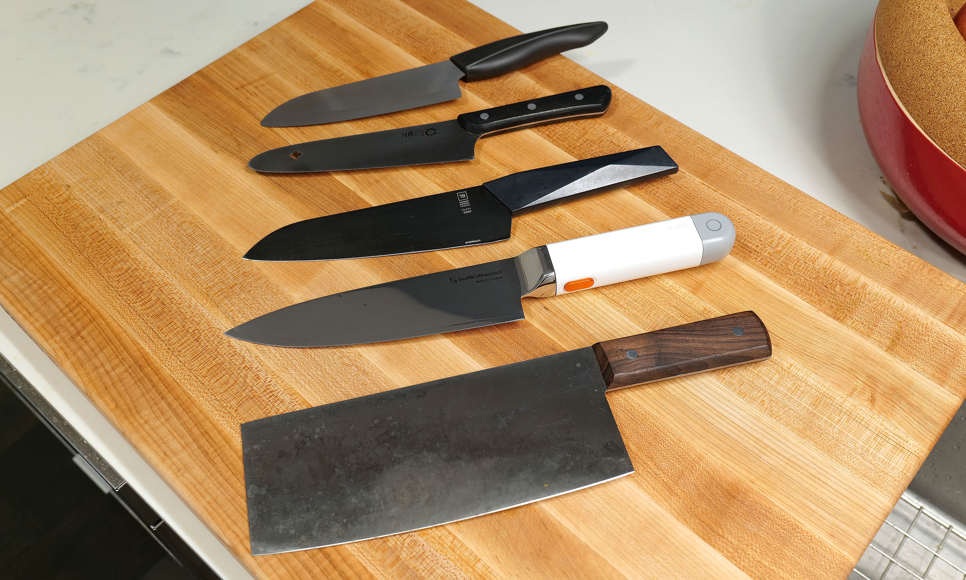 Here's a small selection of knives I own sorted by weight (from top to bottom) compared to the C200: 6-inch Kyocera ceramic knife (97 grams), MAC molybdenum steel chef's knife (110g), Furtif Evercut titanium carbide chef's knife (190g), Seattle Ultrasonics C-200 (328g), Korin carbon steel cleaver (396g).