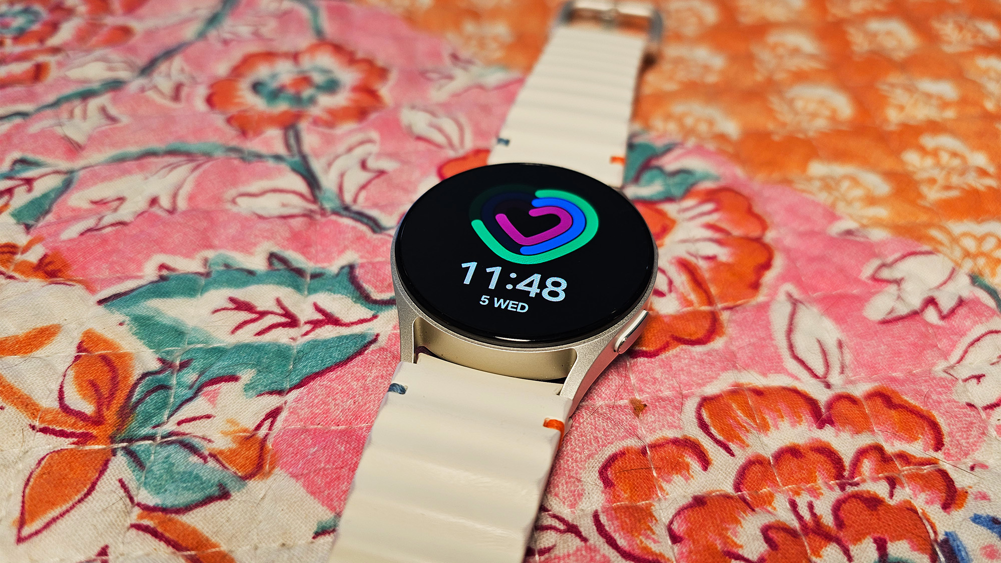 the Samsung Galaxy Watch 7 is set out on a colorful quilt