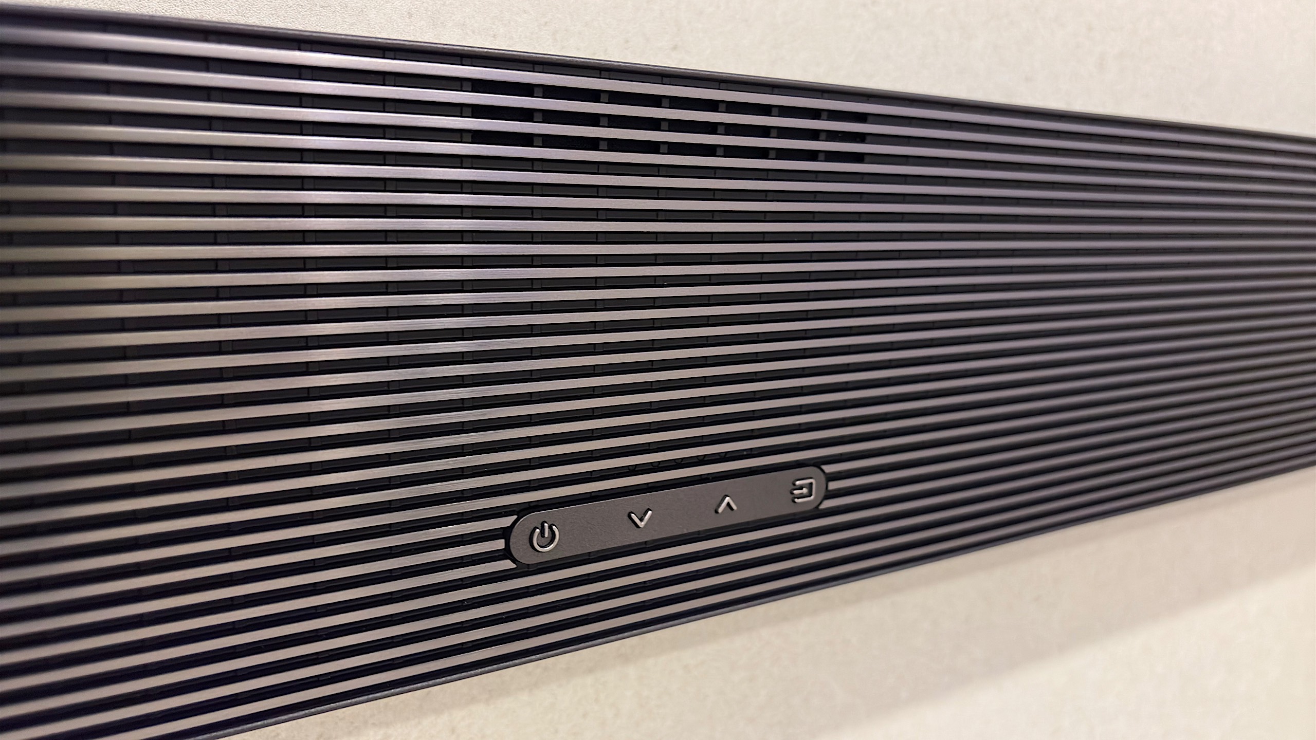 The Samsung QS700F can cut-out buttons on the top or front, depending on which way you mount it. 