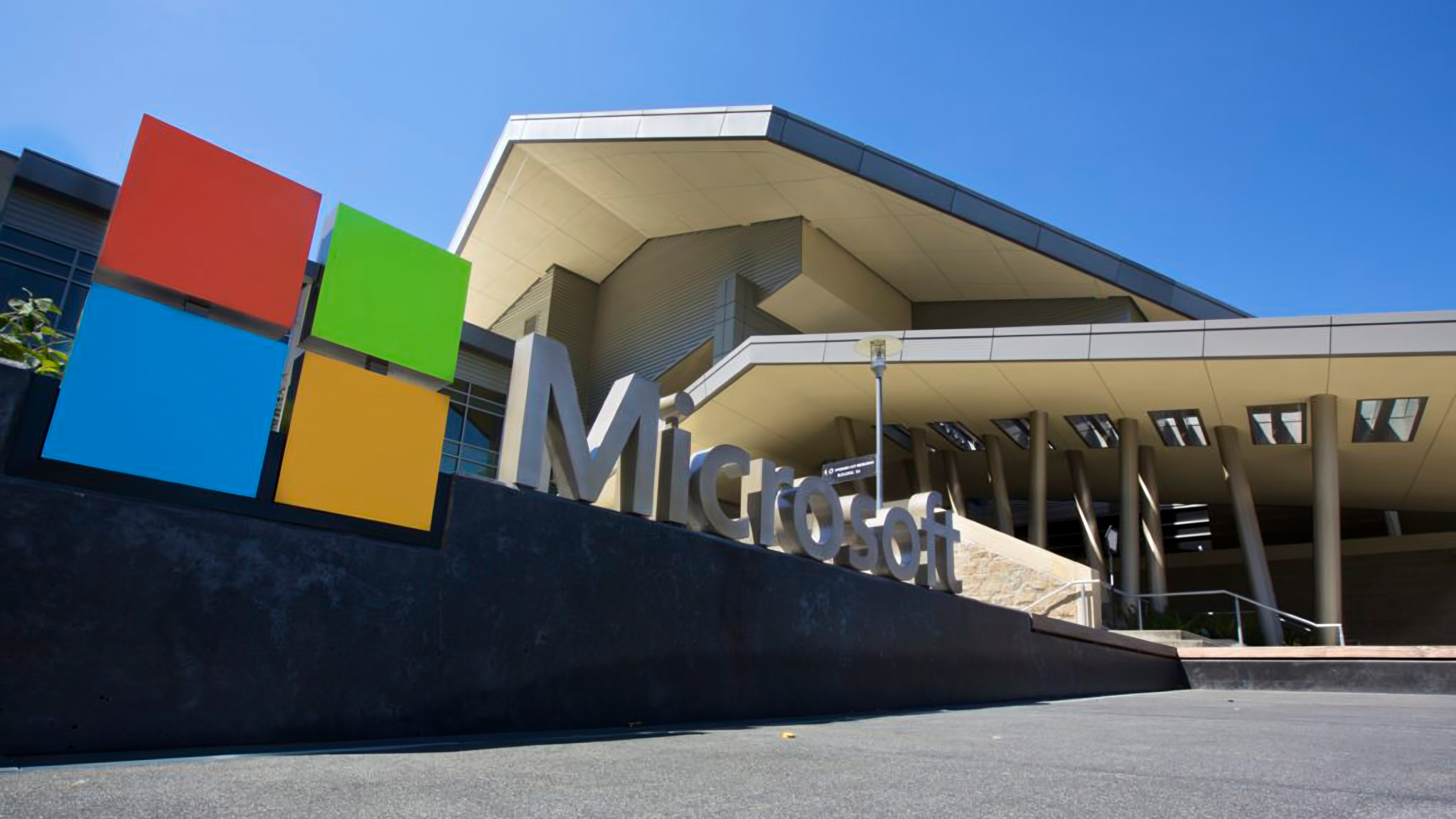 Closeup of a Microsoft logo sign in front of its headquarters.