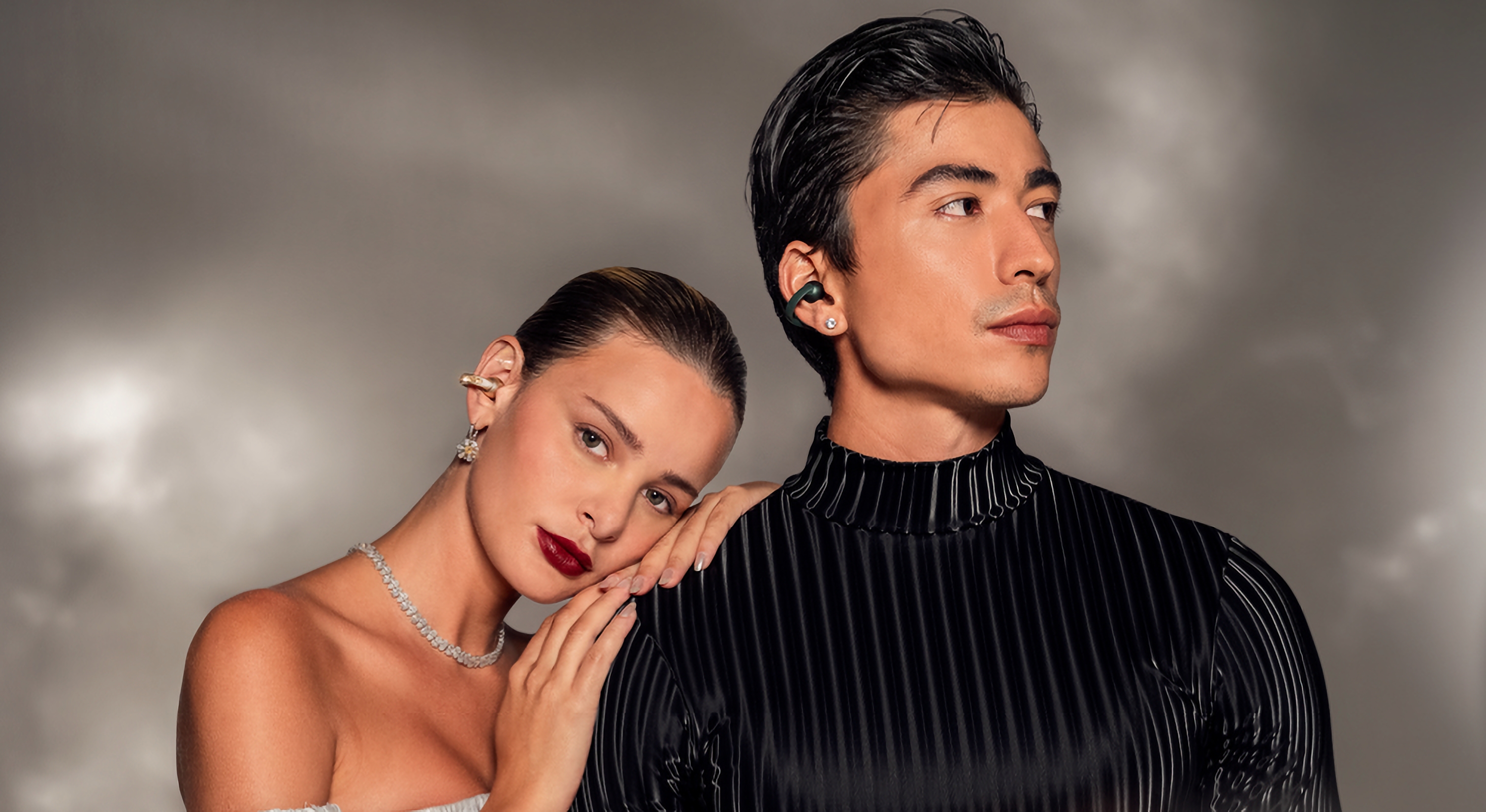 A photo of two models wearing the Moto Buds Loop.