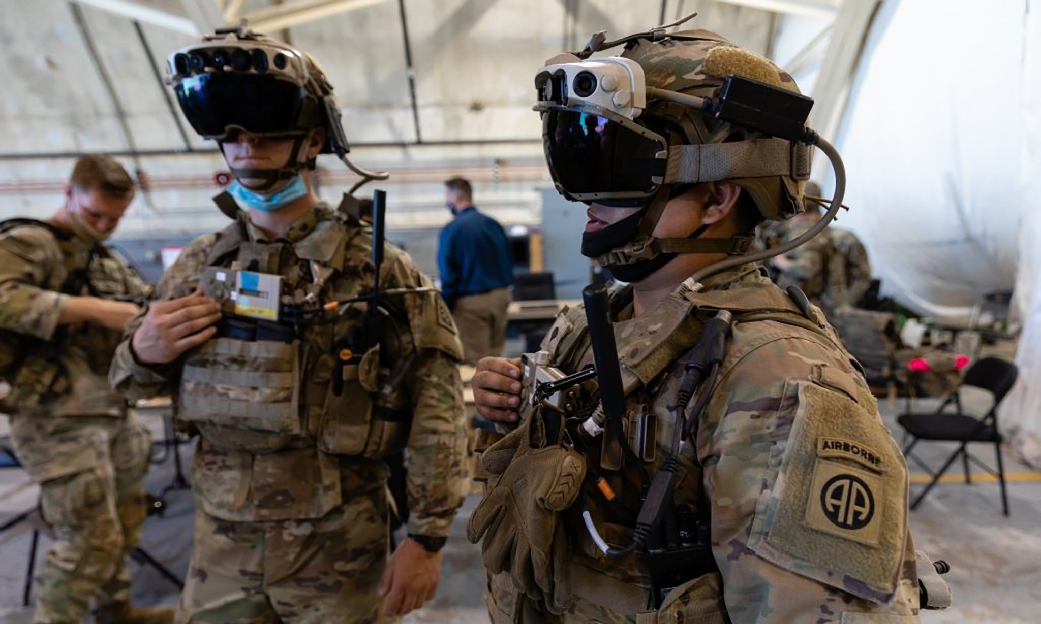 Two US Army soldiers wearing HoloLens-based military AR headsets.