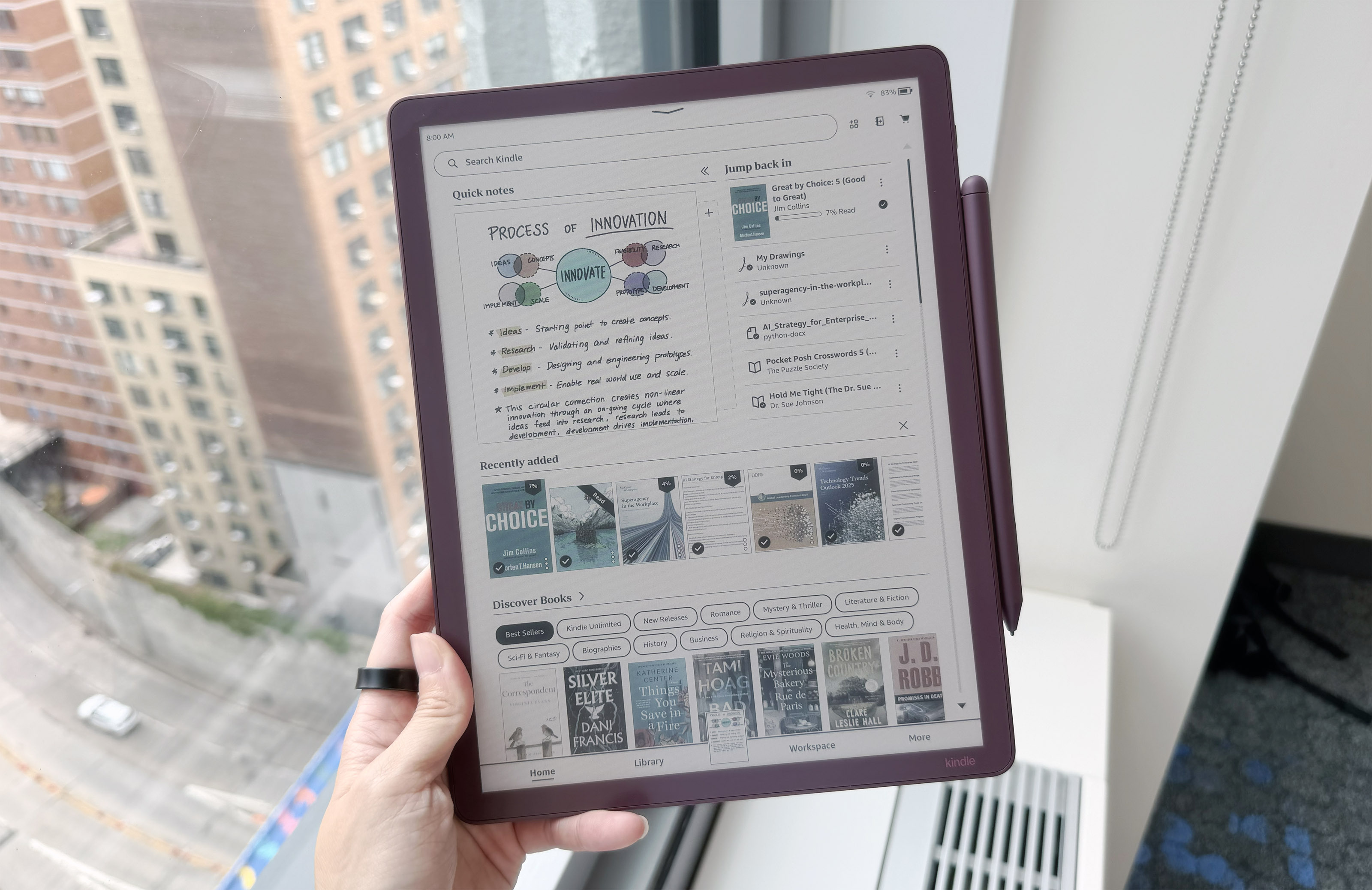 The Kindle Scribe Colorsoft in the fig color option, showing Amazon's redesigned Home page on its display. Notes and book covers are rendered in color.
